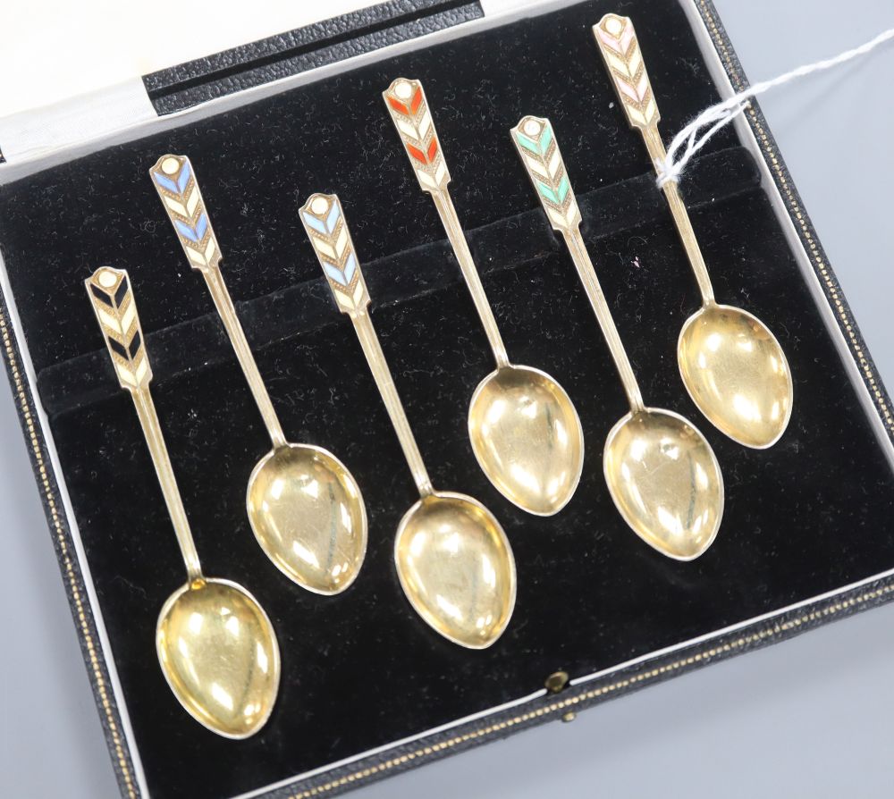 A cased set of six silver gilt and enamel coffee spoons